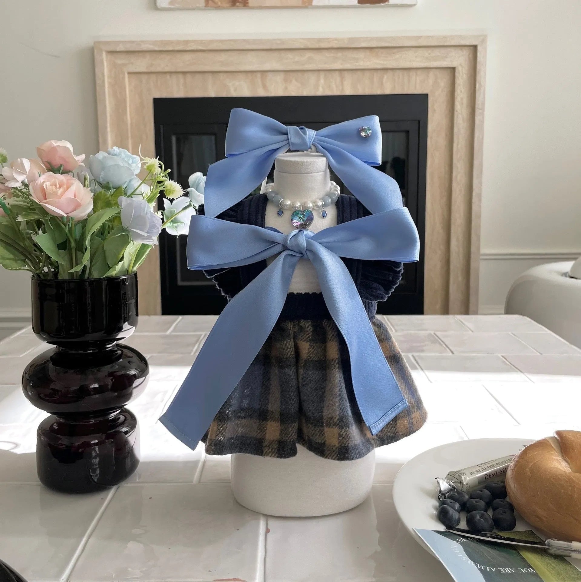 Blue princess style bow dog hair band with adjustable tension on a white background.