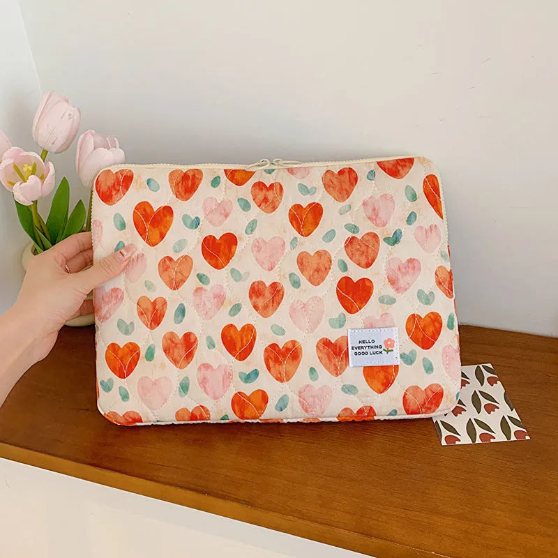 Printed floral design cloth laptop bag for women shown in small, medium, and large sizes.