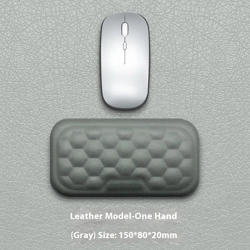 Memory foam mouse wrist pad with silicone bottom in black cloth cover on computer desk