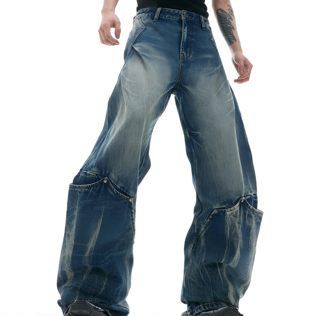 Men's verdant blue loose-fit jeans with a washed burst pattern and curved knife design.
