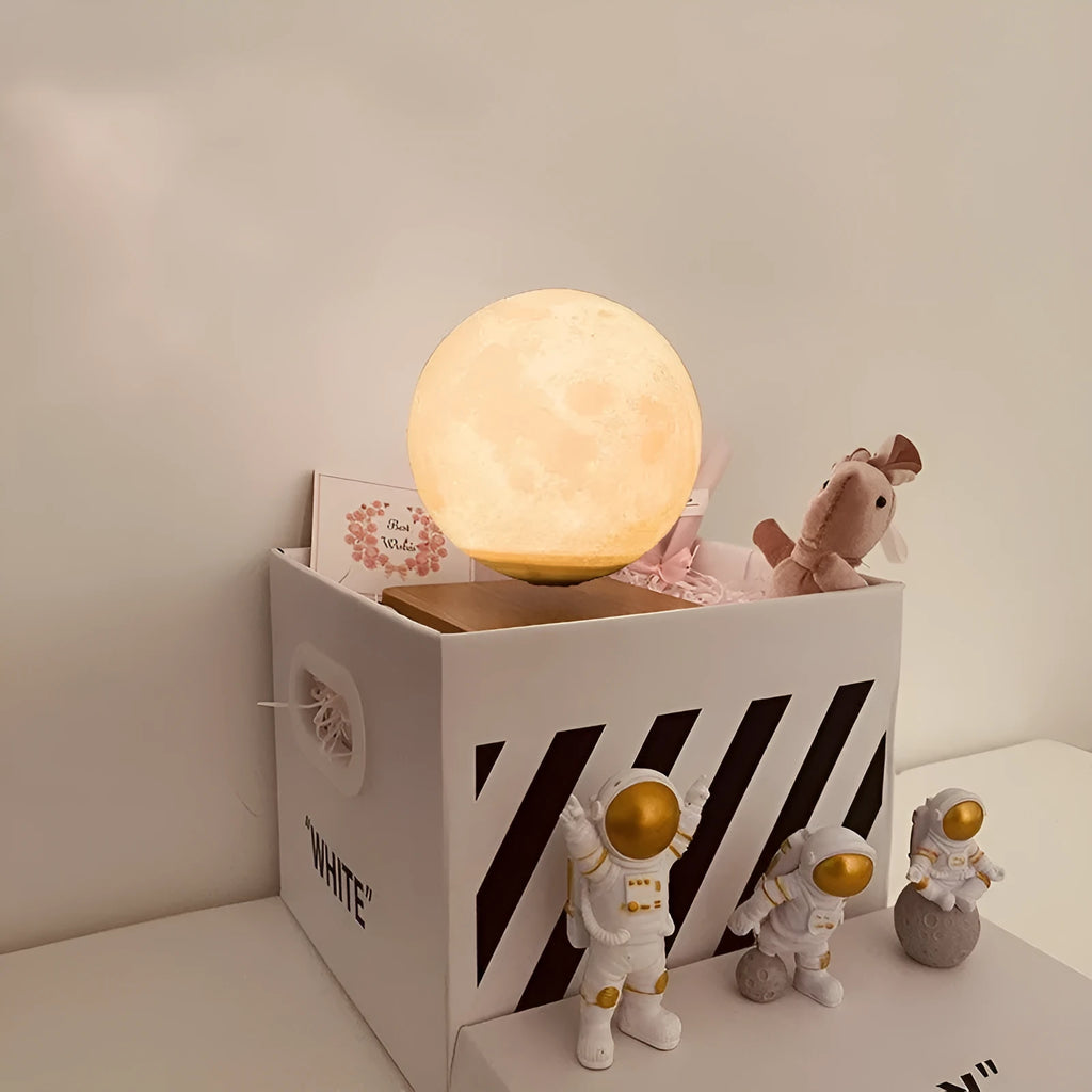 Maglev Moon Earth planet night light floating above base with LED glow, next to astronaut figurines.