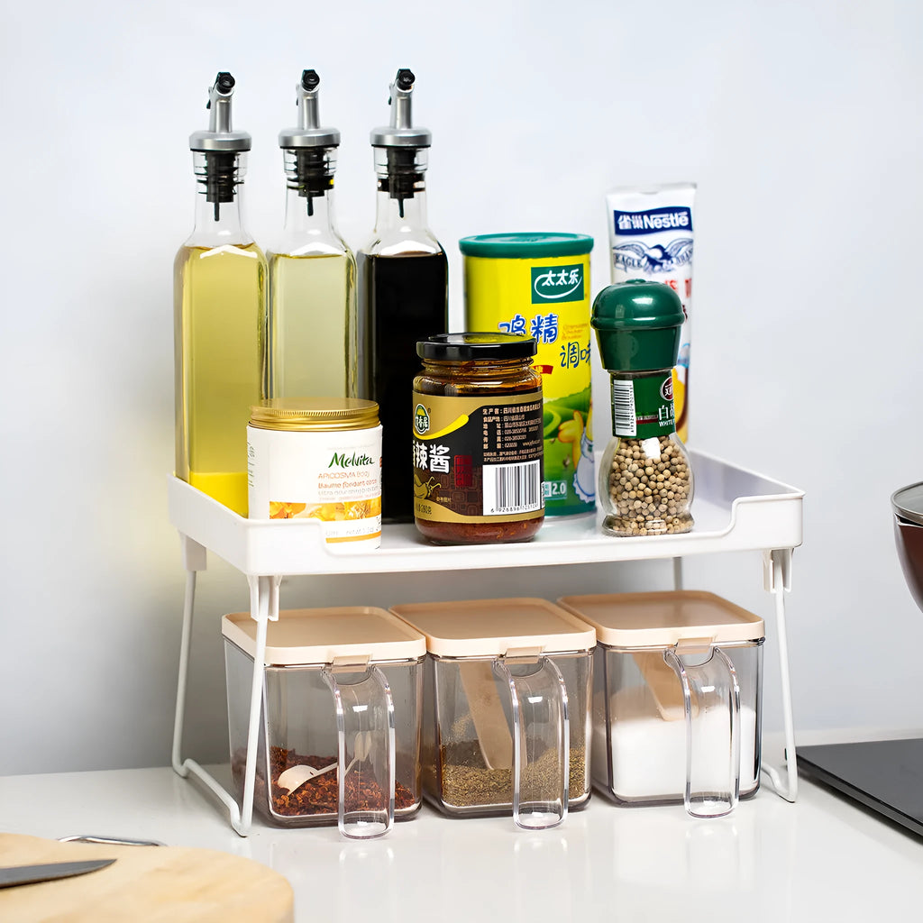 A transparent or white plastic kitchen supplies rack for organising utensils on a desktop or in a cupboard.