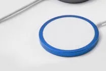 Silver metal magnetic wireless charger for Apple iPhone on a table