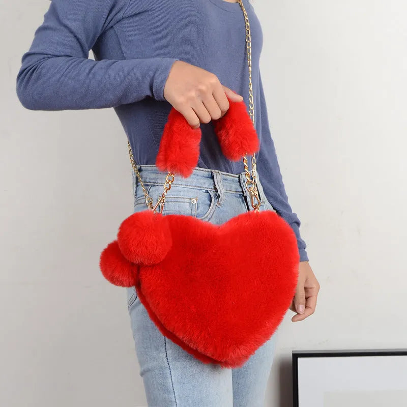 Medium soft plush heart handbag in solid color with zipper closure and shoulder strap option for women