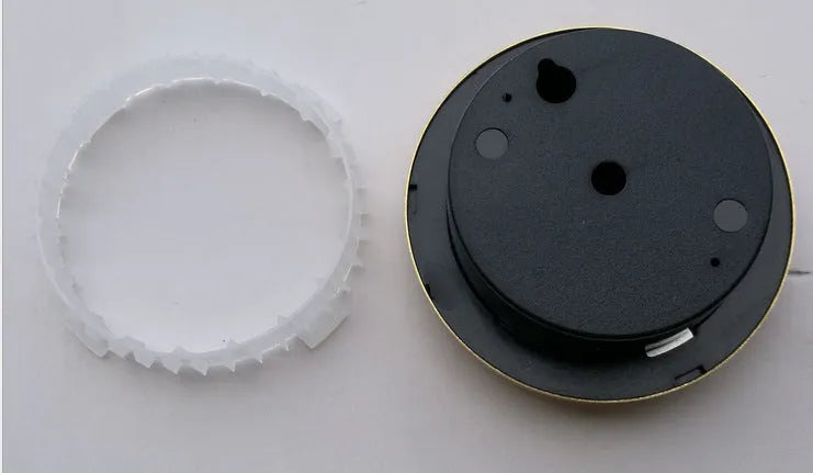 Silver aluminium analog thermometer and hygrometer with a round dial showing temperature and humidity scales.