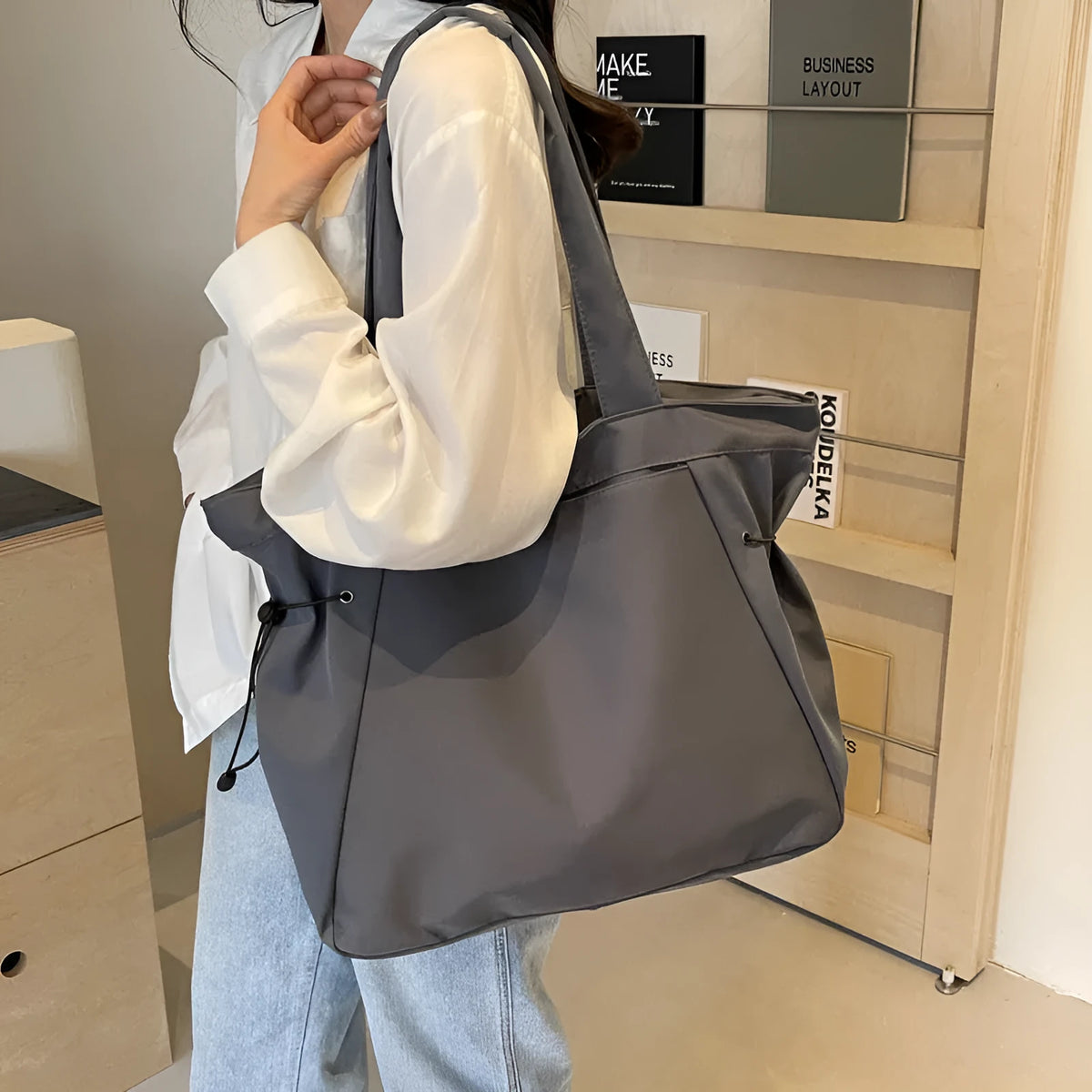 Soft Oxford cloth folding commuter shoulder tote bag shown in light grey colour.