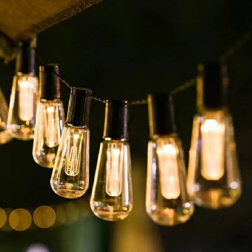Solar retro outdoor string lights with long bulb infusion bottle shape and IP55 waterproof rating