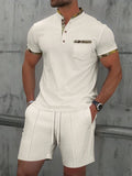 Men's grey waffle texture zipper polo short sleeve top with matching shorts laid flat
