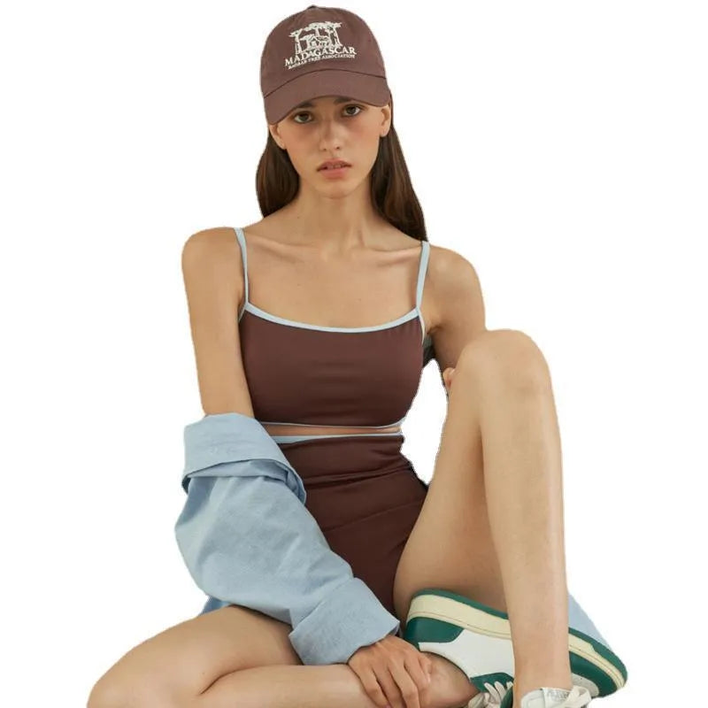 Brown women's one-piece swimsuit with triangle neckline on a hanger.