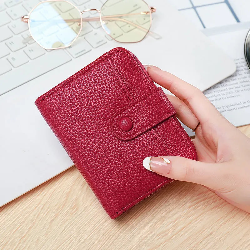Ladies short wallet in PU leather with a lychee pattern, shown folded, in beige, pink, black, and red colour options.