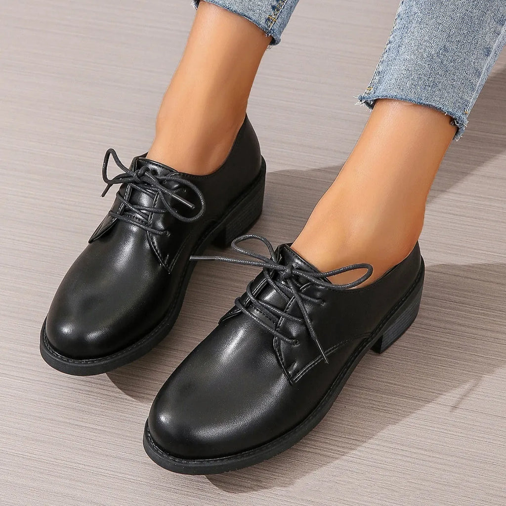Black women's low-top work shoes with a chunky heel and pointed toe.