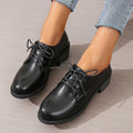 Black women's low-top work shoes with a chunky heel and pointed toe.