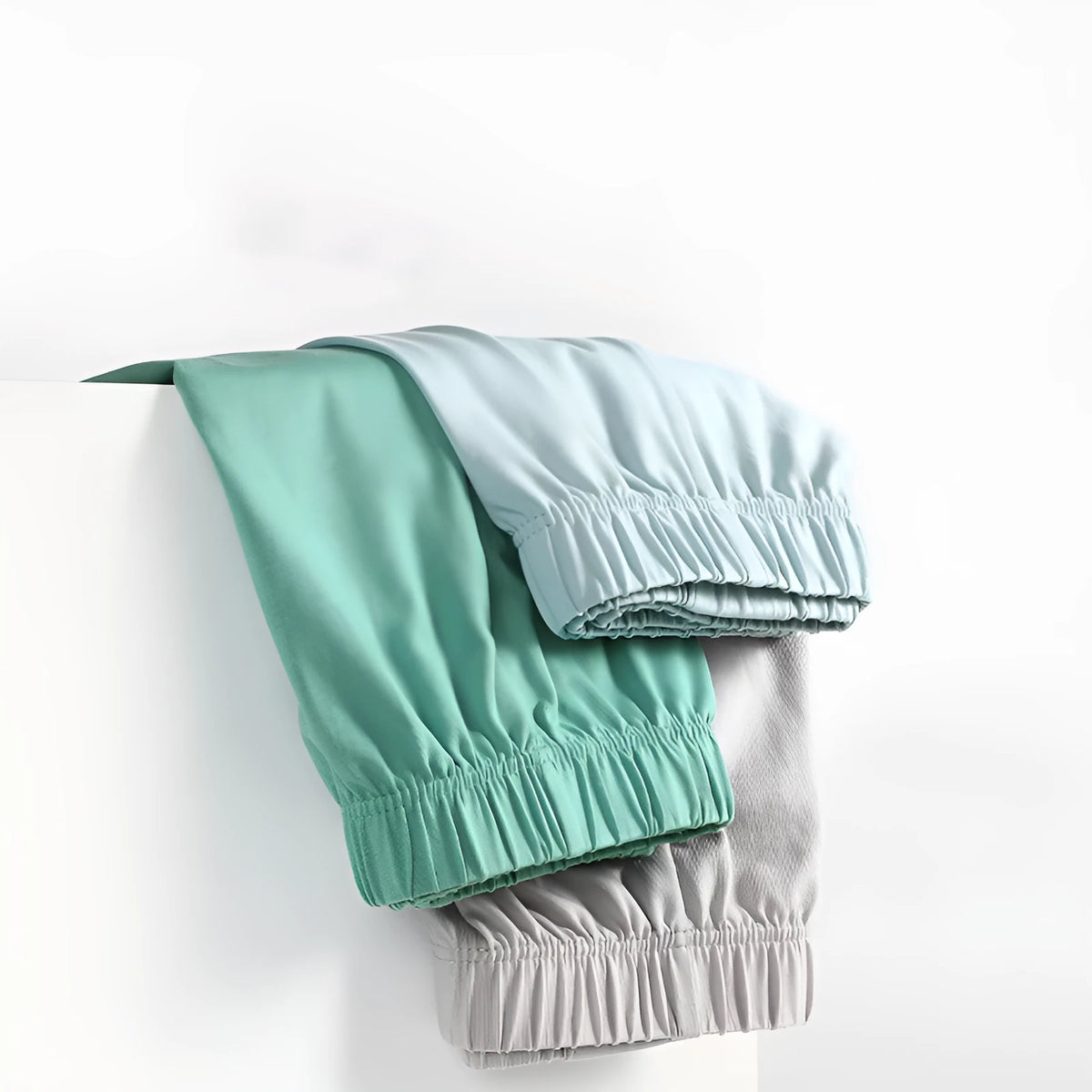 Men's loose-fitting cotton boxer shorts in gold, green, sea blue, and light grey on a mid-waist mannequin.