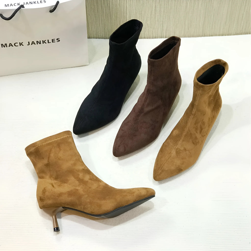 Women's black pointed toe ankle boots with stiletto heels and mid-calf length