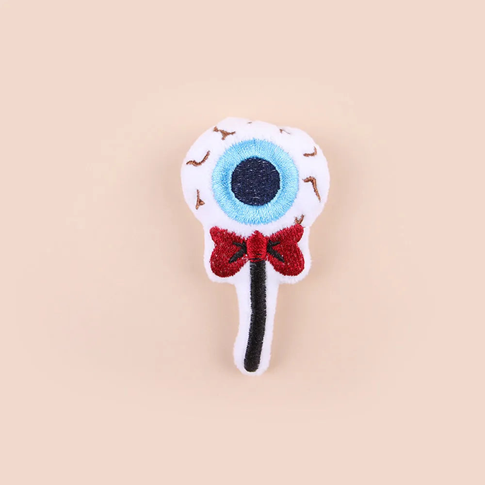 Small cat teaser toy with eyes, candy and skull plush designs on lightweight wand