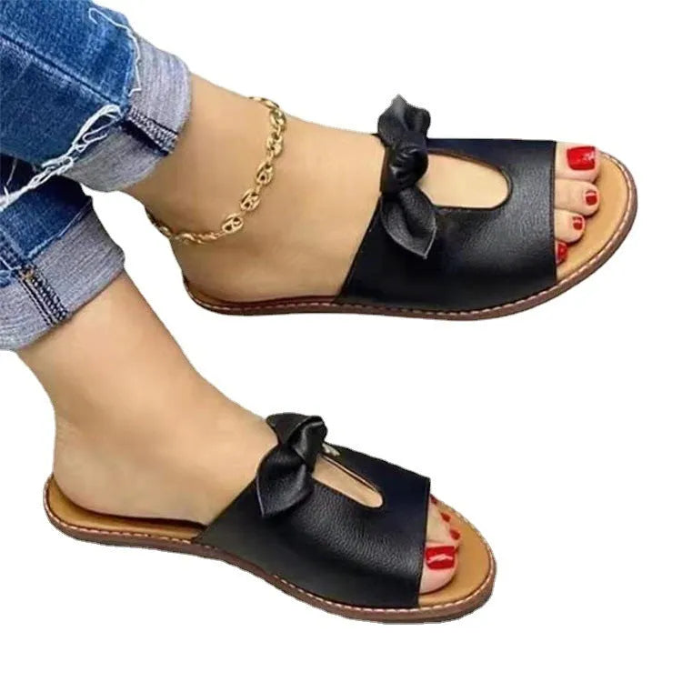 Ladies black fish mouth sandals with a bow decoration on the upper.