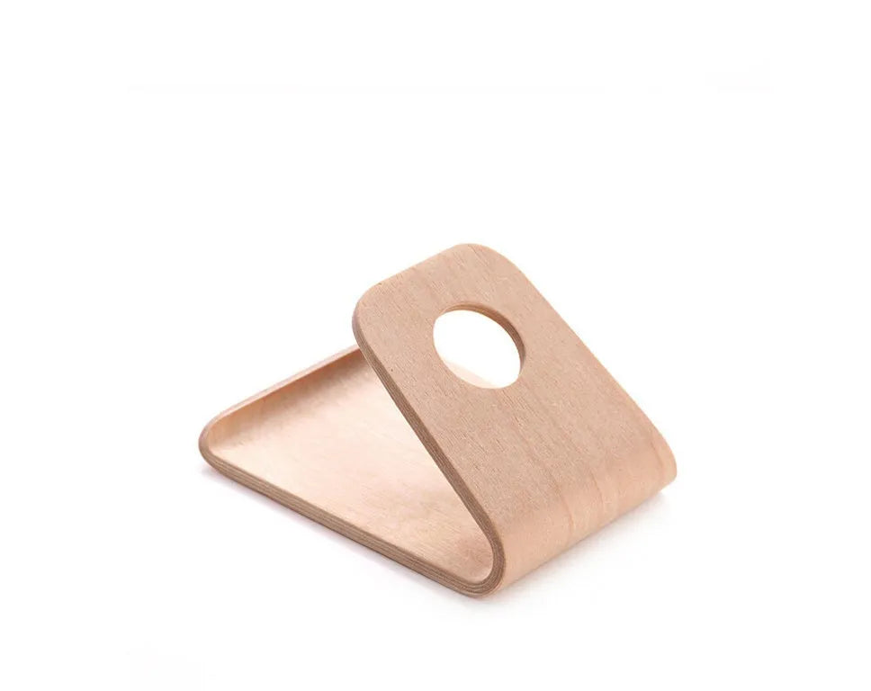 Minimalist wooden phone stand for Apple iPhone in walnut finish on a desk.
