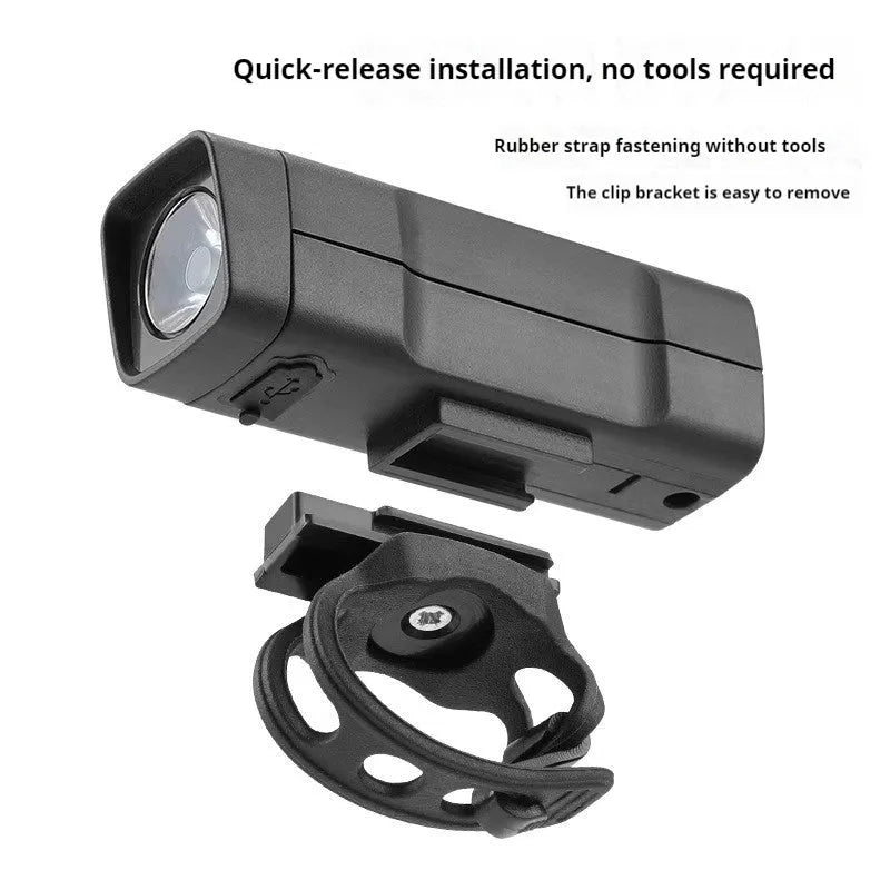Black USB rechargeable bicycle headlight with LED and quick-release strap mount on handlebars.