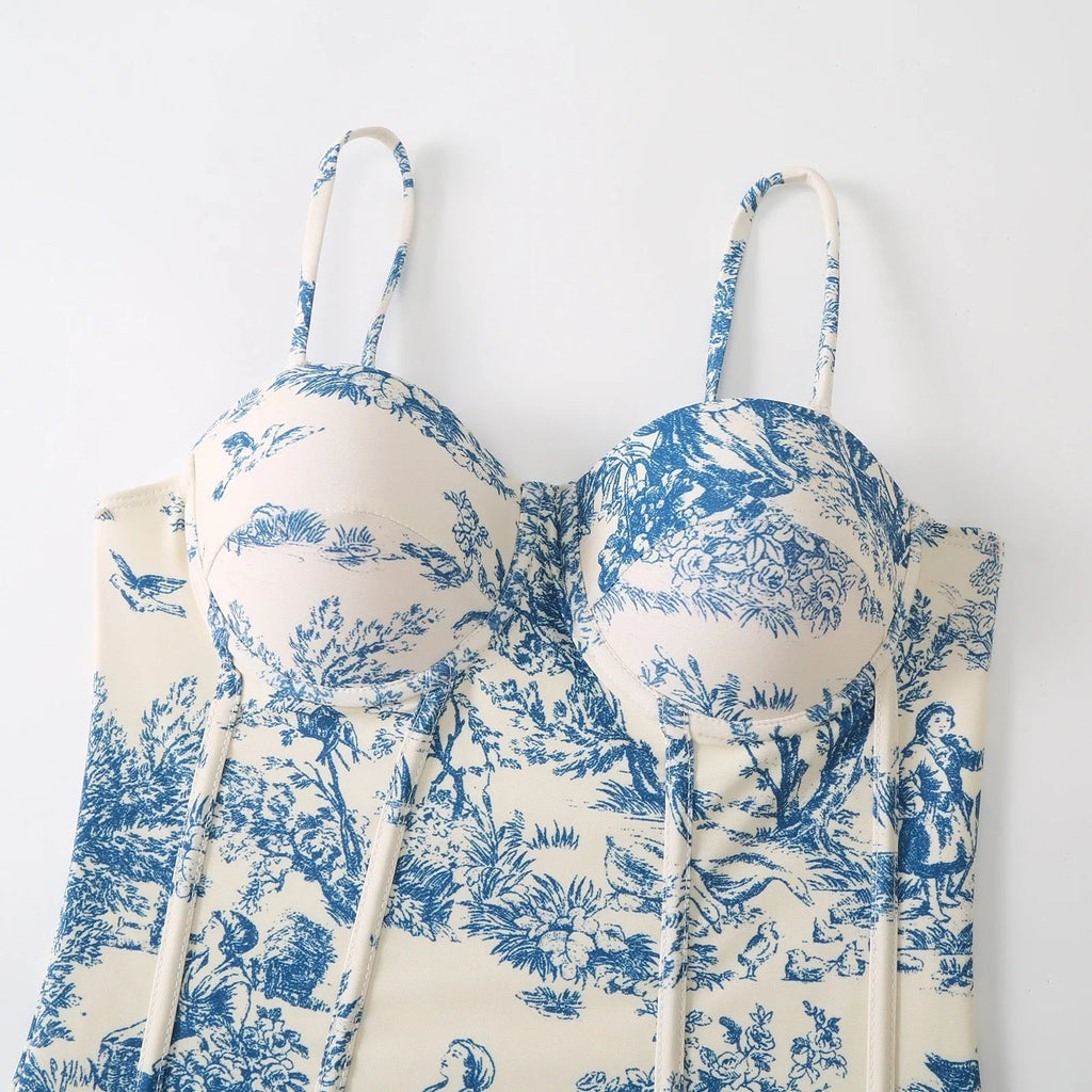 Blue women's one-piece swimsuit with a separate matching gauze skirt laid flat.