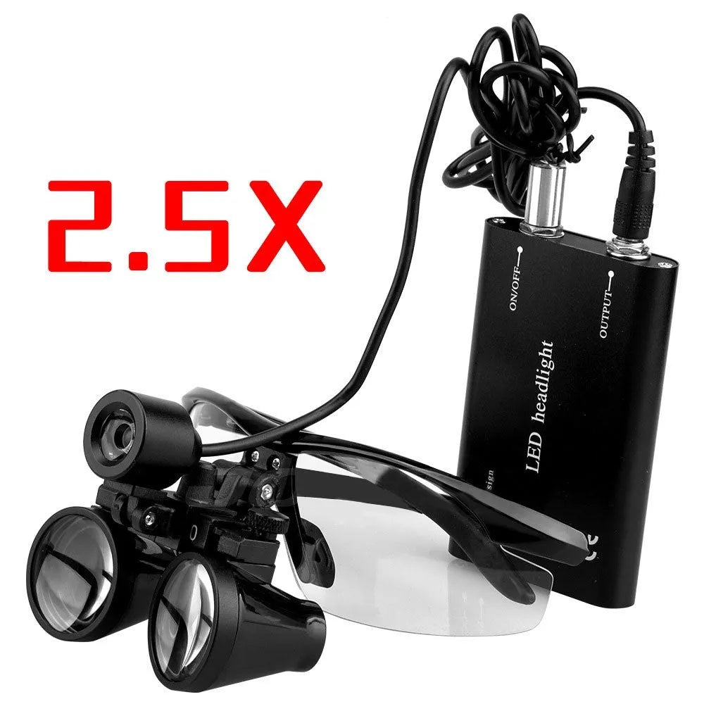 Black head-mounted dental magnifying glasses with LED light on adjustable headgear, shown with included charger and accessories.