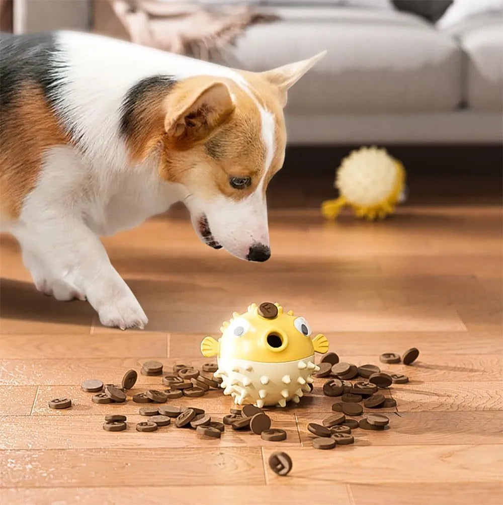 Green fish-shaped interactive dog chew toy with textured surface and internal bell.