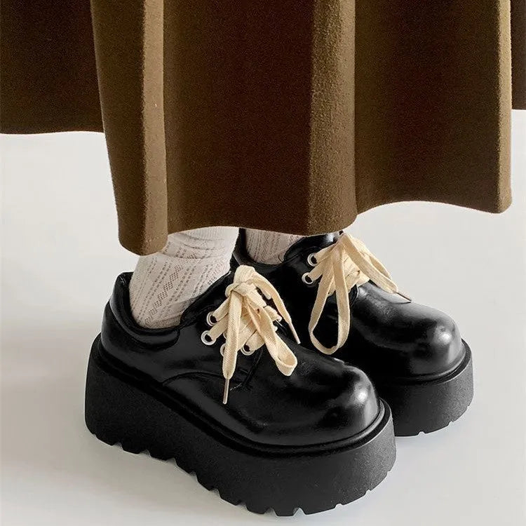 Women's matte black retro ankle boots with a thick rubber sole and buckle fastening on the side.