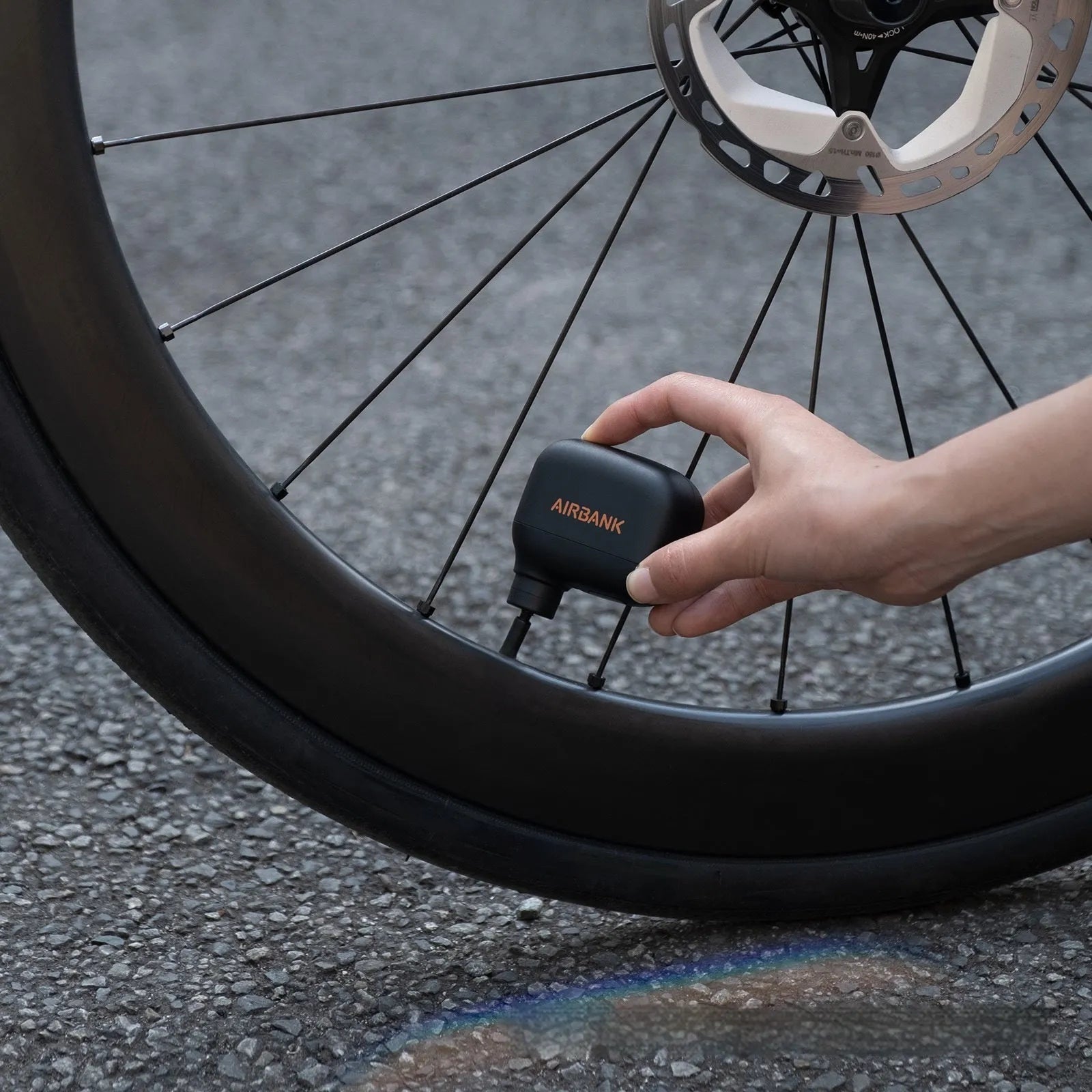 Black AS100 mini electric bicycle pump with USB cable and waterproof bag