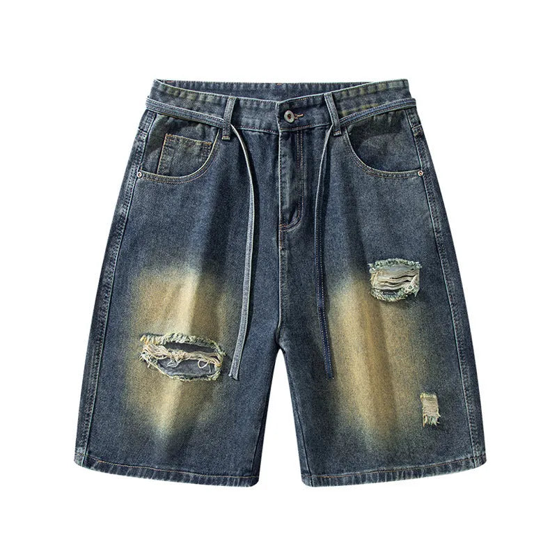 Retro blue loose-fit distressed denim jeans on a hanger, showing ripped detailing.