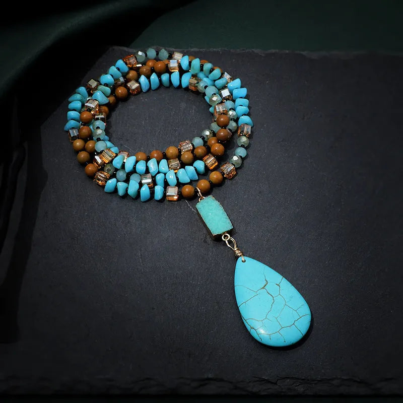 Long turquoise blue water drop pendant necklace with mixed gem inlay on a ball bead chain for women.