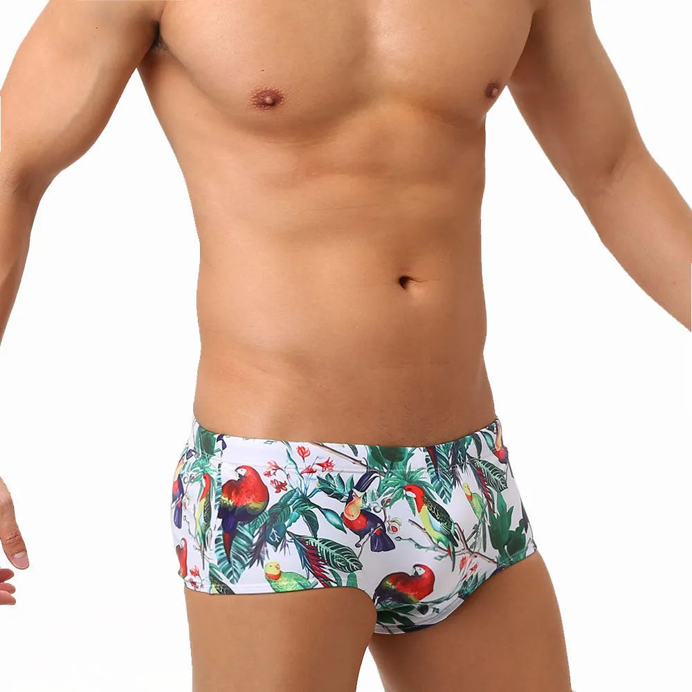 Men's navy swim trunks with colourful flower and bird print pattern, boxer style