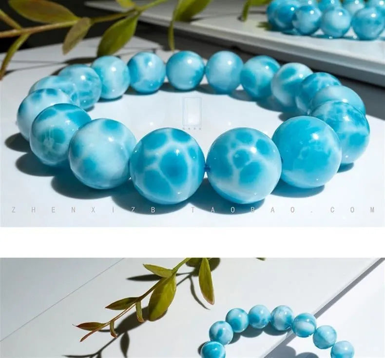 Blue Bodhi bracelet with natural sea-pattern crystal bead and pearl details in Maillard style.