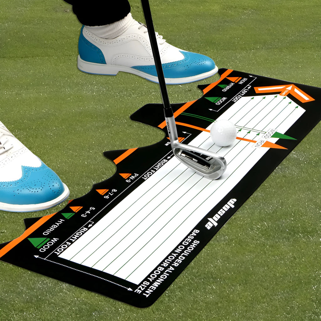 Black neoprene golf swing posture aid mat on grass, showing its compact size and alignment markings.