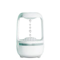 White anti-gravity humidifier with upward-flowing water droplets on dark surface