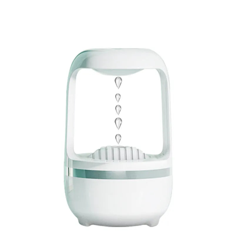 White anti-gravity humidifier with upward-flowing water droplets on dark surface