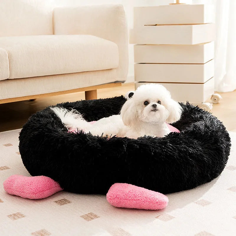 Elf Briquettes blue plush kennel-style dog bed with raised edges, shown in a home setting.