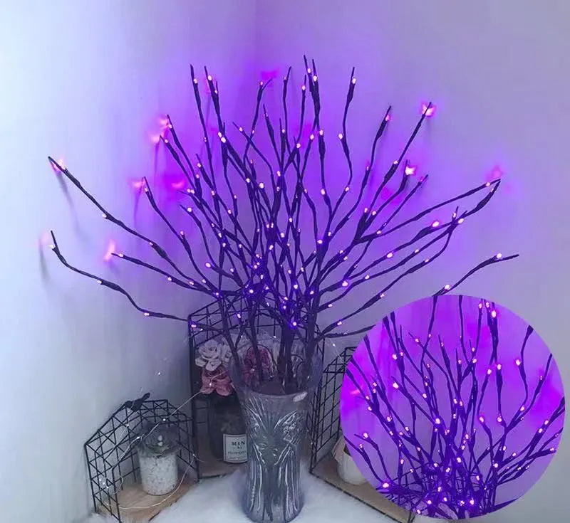 LED decorative tree light with silver branches in a vase, emitting coloured light.