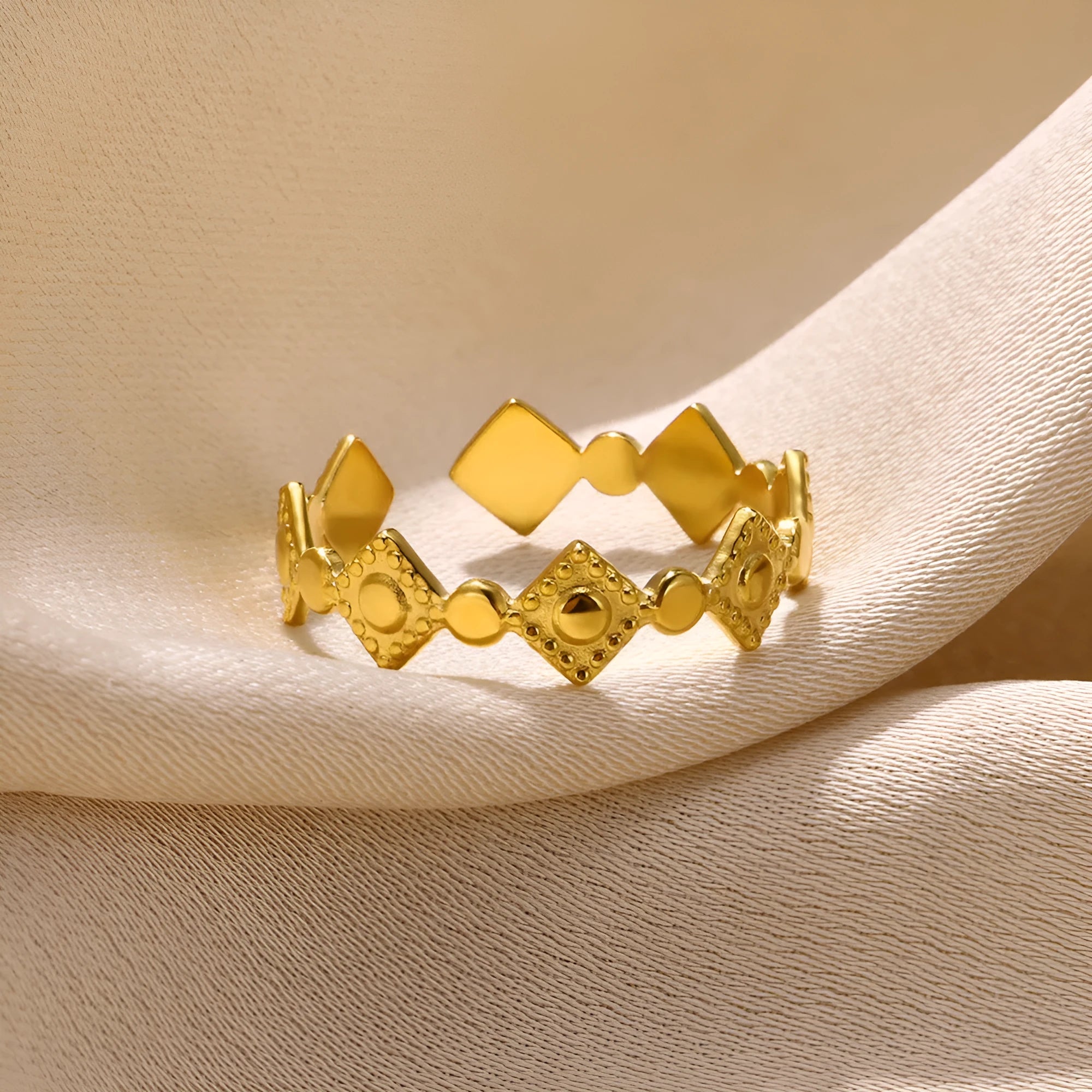 Gold diamond geometric titanium steel ring for women on a plain background