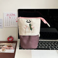 Cartoon design collapsible pencil case in brown or green Oxford fabric, shown open to display large 17cm x 14cm storage capacity.