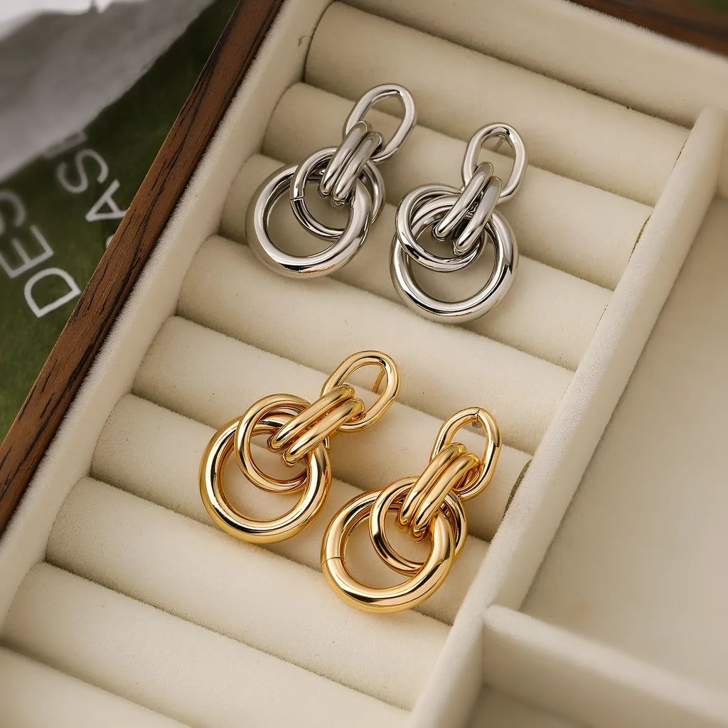 Gold-colour geometric earrings with irregular shapes and INS high-profile design