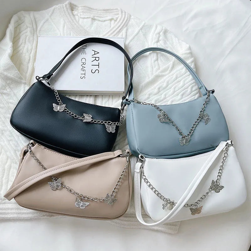 Butterfly chain underarm bag in horizontal square shape with detachable strap and organised interior
