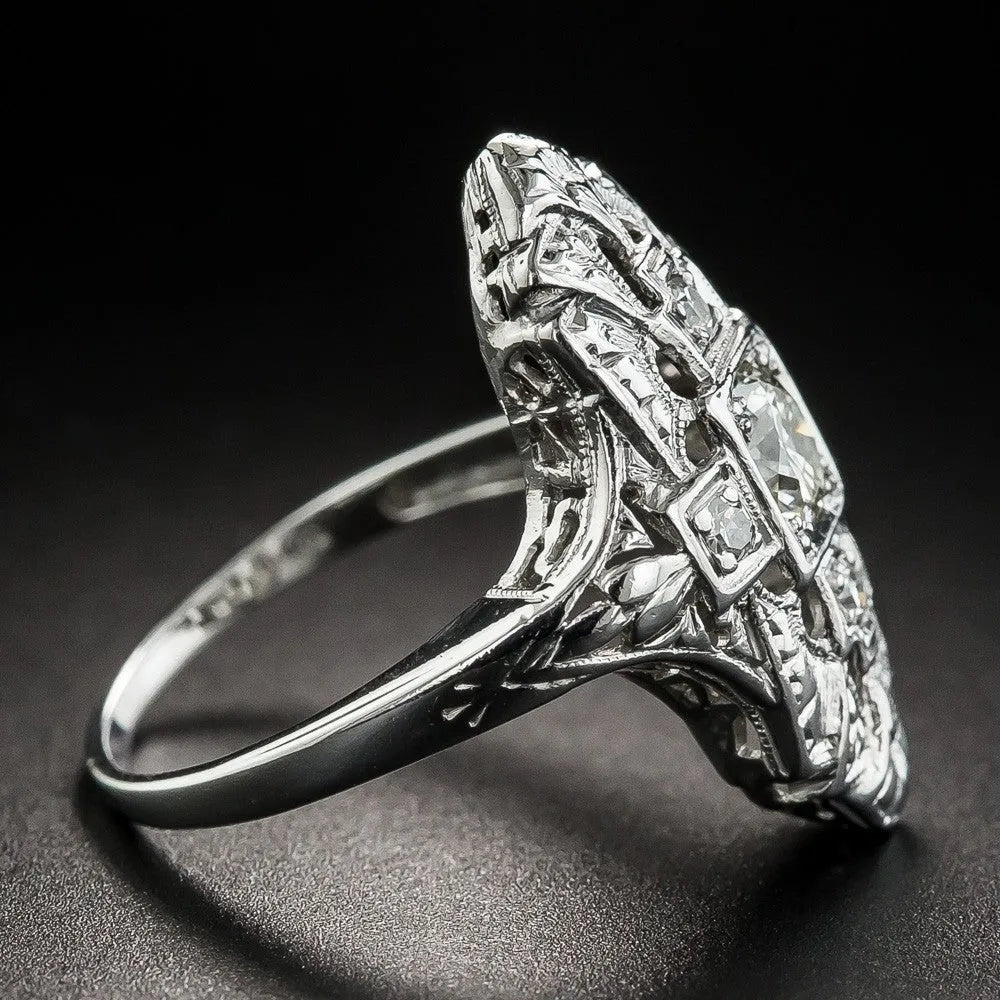 Geometric hollow out silver ring with diamond studs on a copper base.
