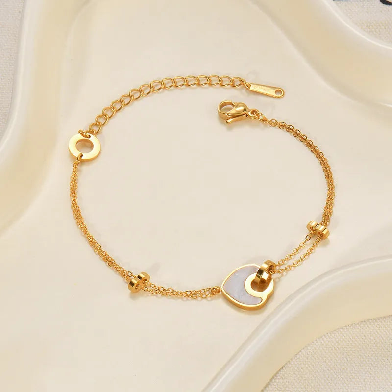 Double-layer heart-shaped stainless steel resin bracelet for women with electroplated finish.