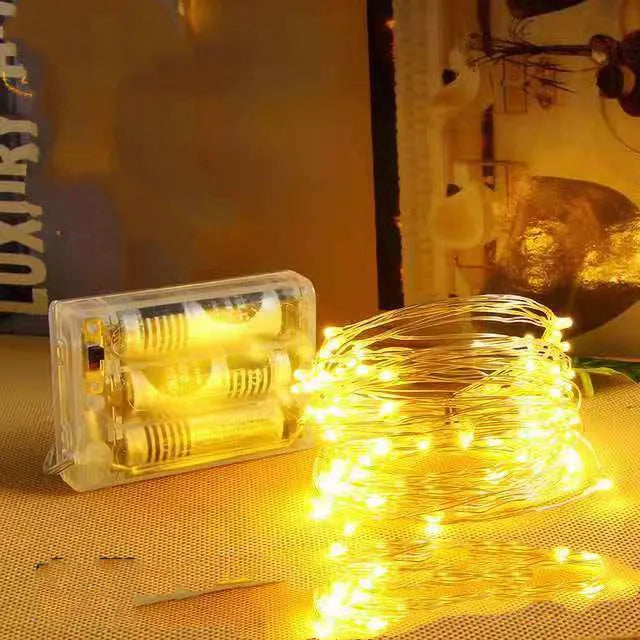 Copper wire string lights with battery box showing flexible wire with LED bulbs in various colour options