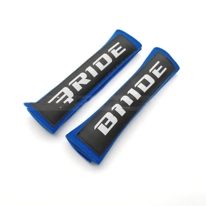 Car seat belt shoulder pads in black, blue, and red colours showing cotton sponge cloth with embroidery weaving