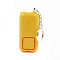 Small pink personal safety alarm on a keyring with a white box.