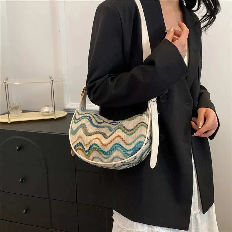 Women's straw woven crossbody bag showing internal mobile phone pocket and file compartment.