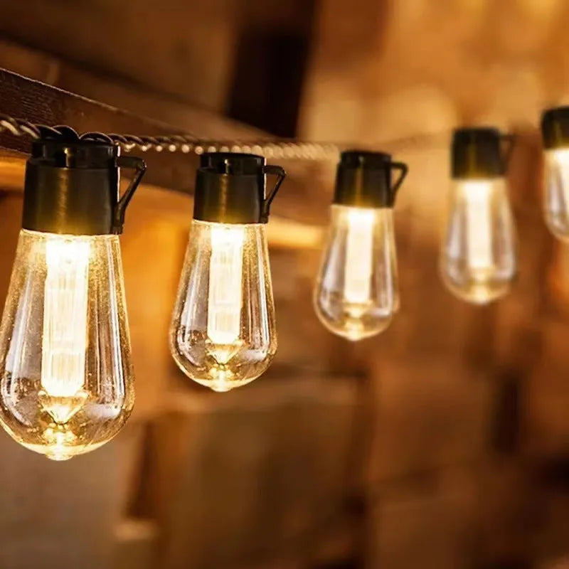 Solar retro outdoor string lights with long bulb infusion bottle shape and IP55 waterproof rating