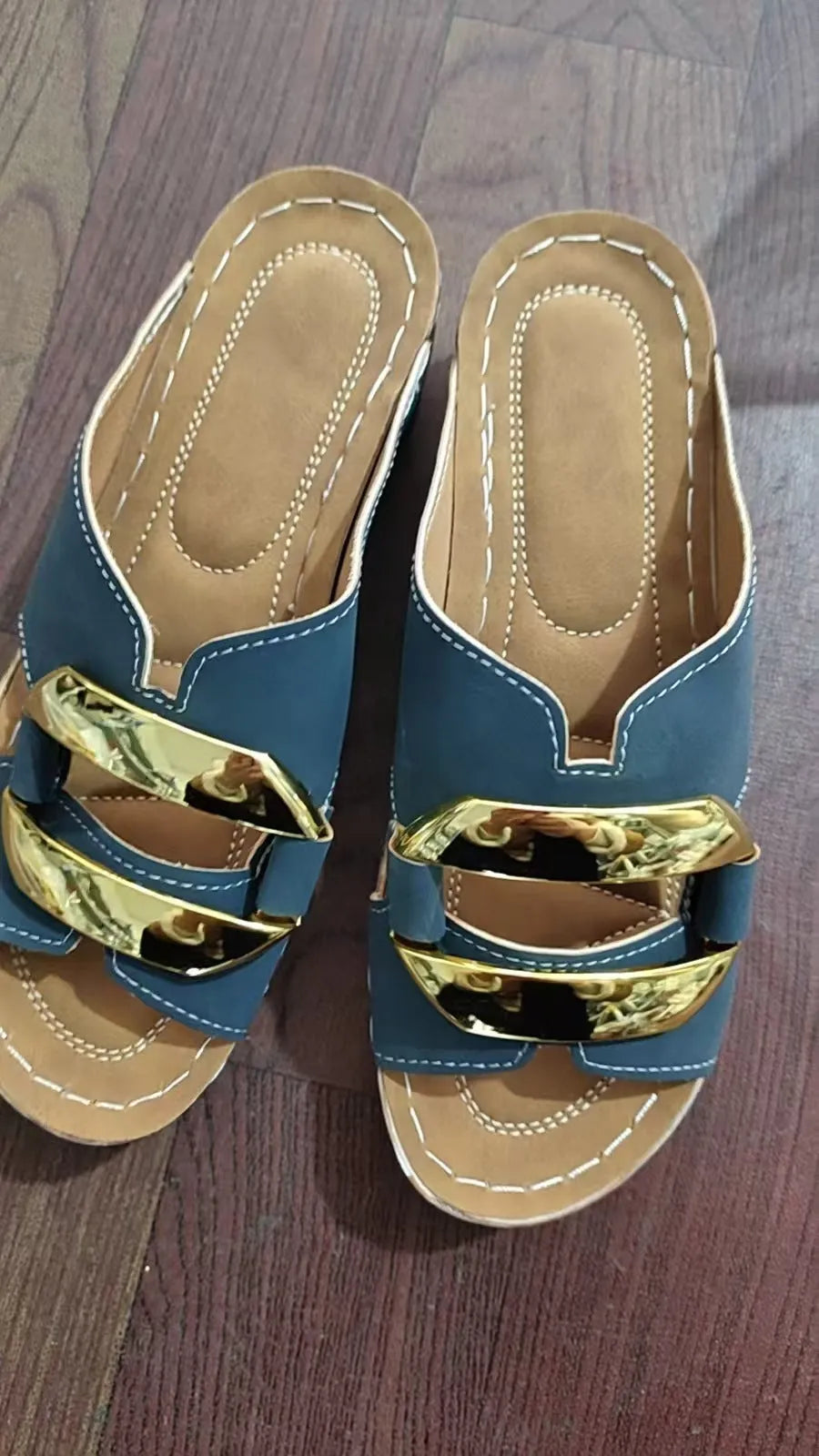 Men's white Roman-style platform sandals with a flat rubber sole and decorative metal details on the strap.