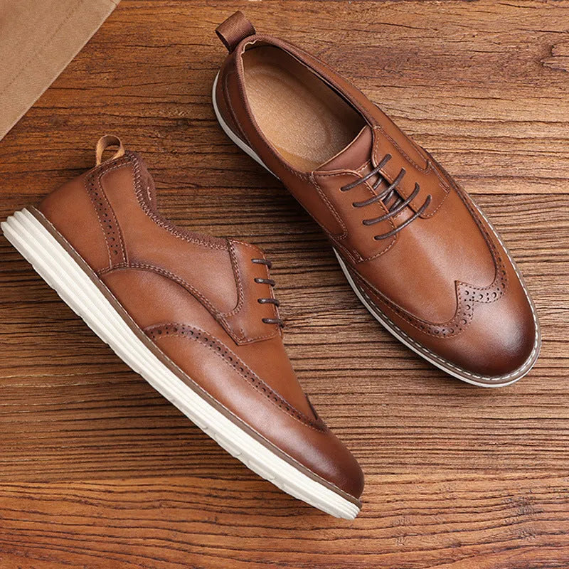 Men's black slip-on business casual shoes with decorative carving on the PU leather upper