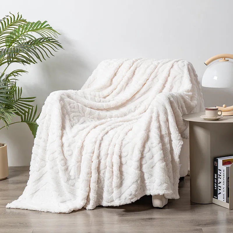 Shu cotton velvet jacquard sofa blanket in a solid colour draped over a modern sofa